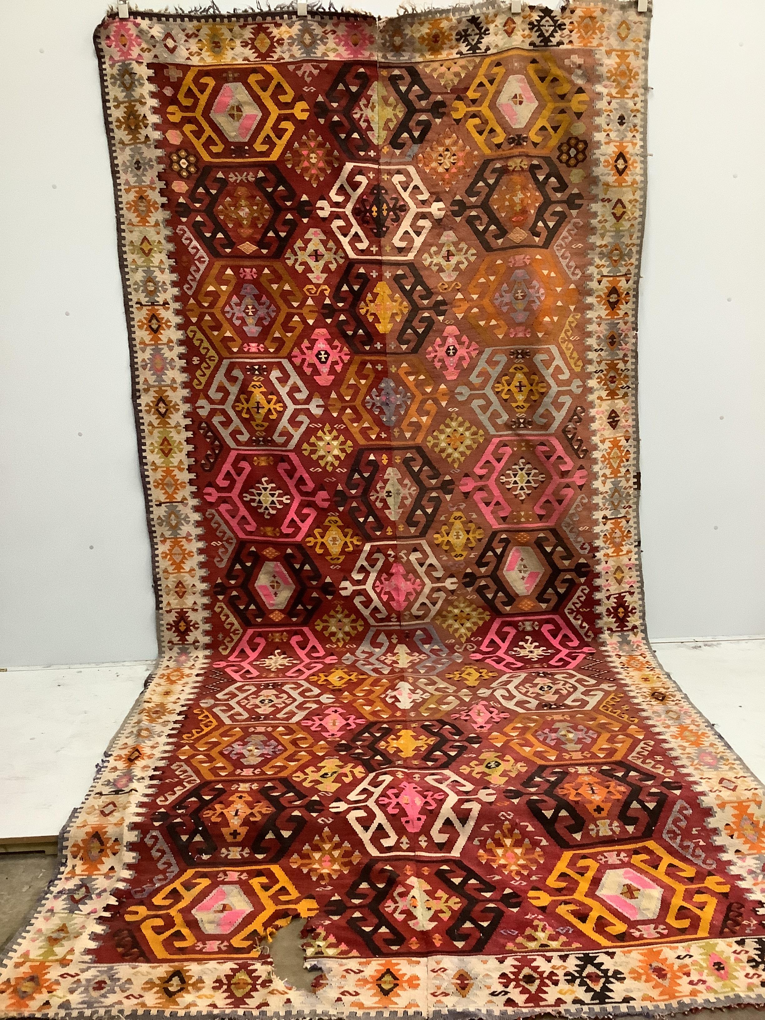 A Kilim polychrome flatweave carpet, approx. 400 x 380cm